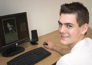 Happy young man at desktop PC