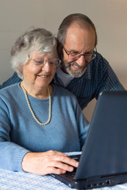 Happy senior couple with laptop