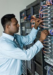 Male technician repairing network server